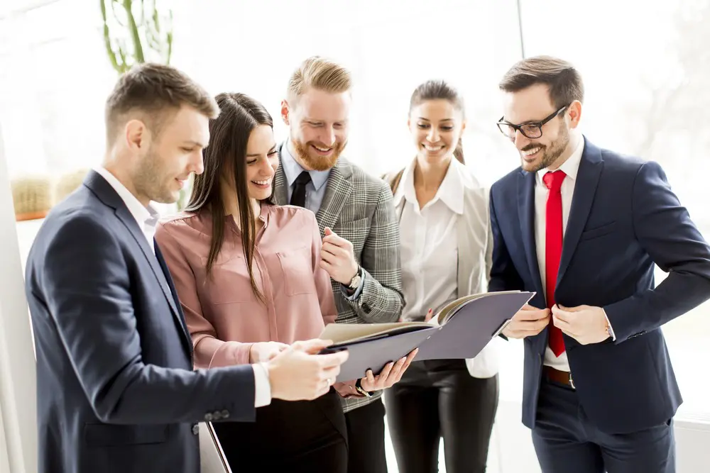Car dealership employees review safety training materials