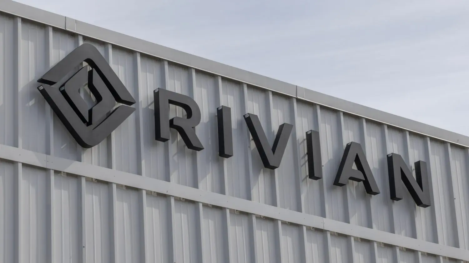 Rivian settles a $250 million IPO fraud lawsuit as it cuts jobs and refocuses on its R2 SUV launch amid slowing EV demand.