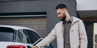 Prices, range and charge times are holding electric vehicles back Man charging one of his battery electric vehicles