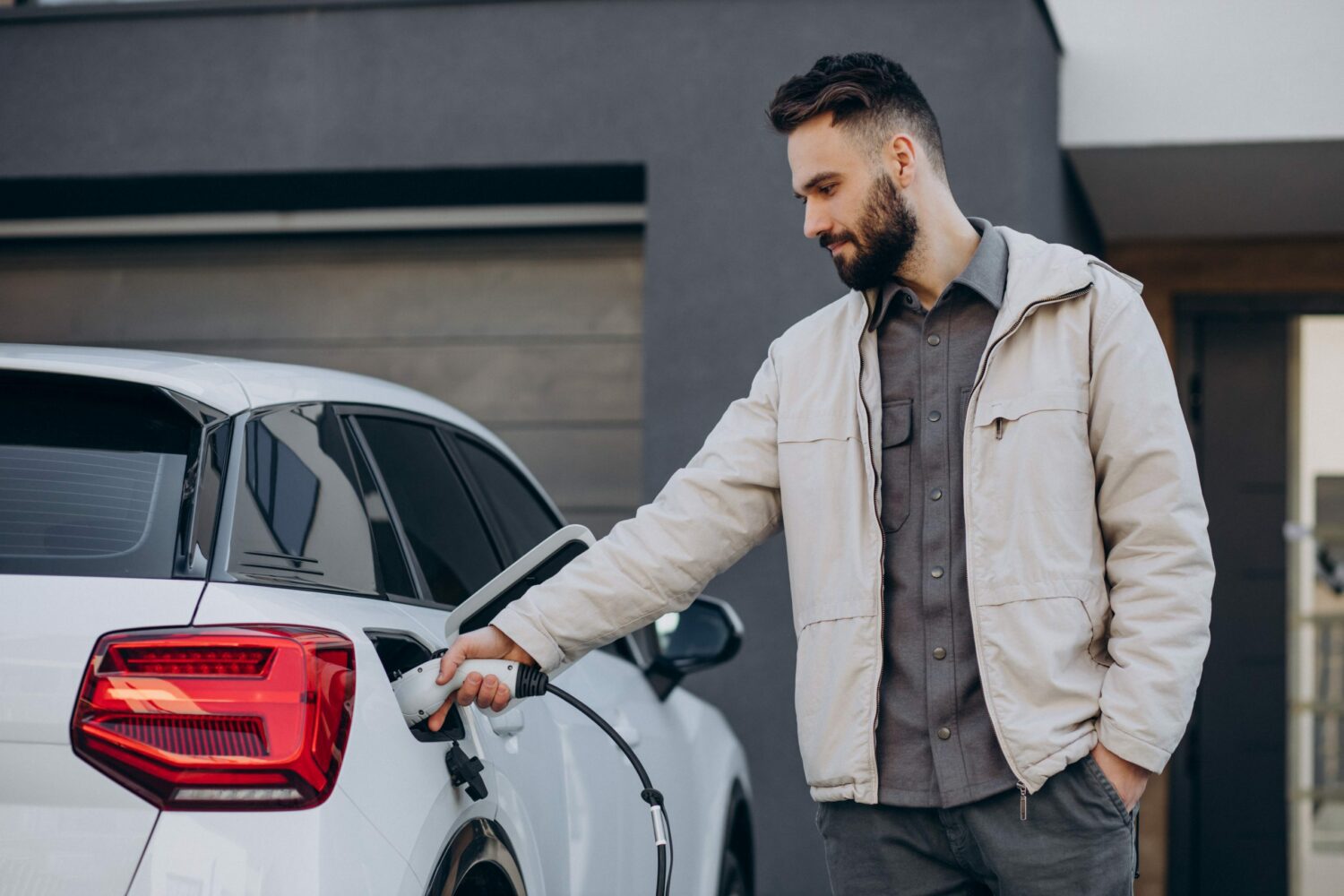 Man charging one of his battery electric vehicles