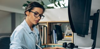 8 tips to revamp your dealership ad designs for today’s modern customers Graphic designer sketching new ad designs on tablet.